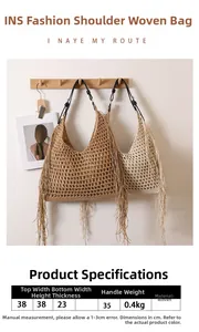 Detail of woven beach bag with long tassels and black leather handles in boho style