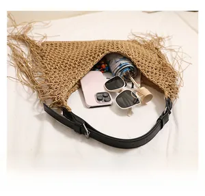Straw shoulder bag with fringe detail showing internal capacity for daily essentials