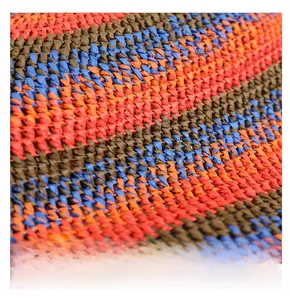 Detailed close-up of woven straw texture with orange, blue, and brown striped patterns