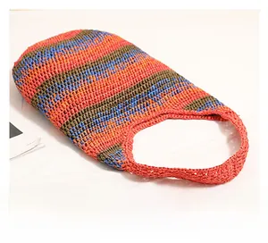 Top-down view of colorful striped woven tote bag with open-top design for beach travel