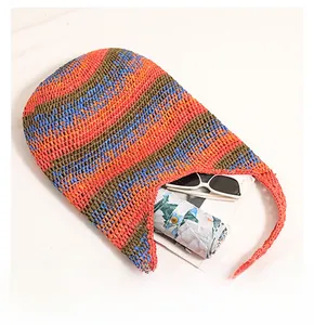 Detailed view of the large capacity interior of a colorful striped woven straw beach tote bag