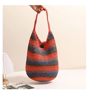 Detail of colorful striped straw tote bag showing vibrant texture and spacious interior