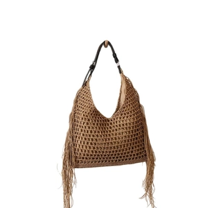 Chic woven straw shoulder bag with tassels and adjustable leather strap for beach vacations