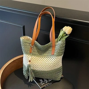 Striped crochet tote bag with brown leather handles and decorative wood bead tassels