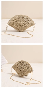 Close-up of shell-shaped straw bag with hollow woven texture and gold chain strap