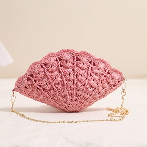 Elegant pink shell-shaped straw woven crossbody bag with delicate gold chain strap