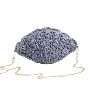 Shell-shaped woven straw crossbody bag with gold chain strap for beach vacations