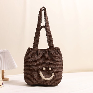 Brown woven cotton crochet shoulder bag with cream smiley face pattern for beach vacation