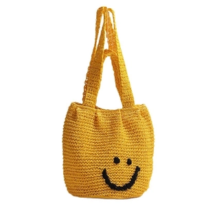 Yellow knit tote bag with a black smiley face pattern for beach or summer casual use