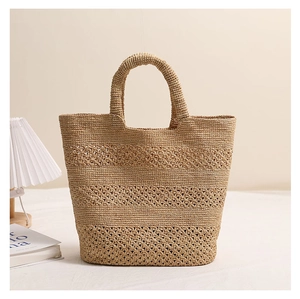 Detail showing the intricate hollow weave patterns on this raffia beach tote bag