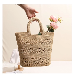 Detail of hollow-out woven pattern on a raffia tote bag with flowers for beach vacation
