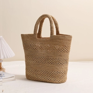 Handwoven raffia straw tote bag with floral hollow design for beach vacations