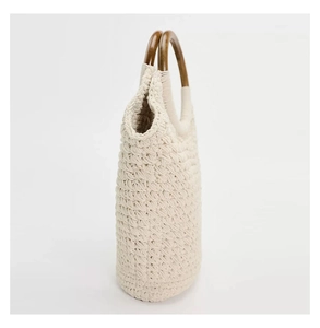 Detail view of cotton rope weave texture and dark brown wooden circular handle