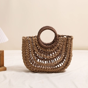 Handcrafted straw woven handbag with hollow mesh design and round wooden top handle