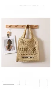 Detailed size specifications of a woven straw shoulder bag with AMOUR PARIS embroidery