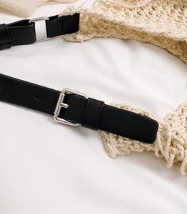 Close-up of black leather belt featuring silver metal pin buckle and precise stitching