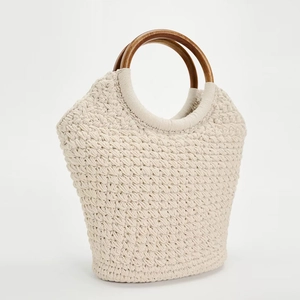 Large cotton rope woven tote bag with round wooden handles for beach and vacation use