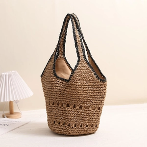 Large capacity handmade straw tote bag with hollow woven design and black trim for beach