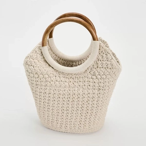 Large cream cotton woven tote bag with round wooden handles for summer beach vacations