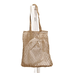 Hollow mesh woven shoulder bag with white drawstring inner pouch for beach vacation