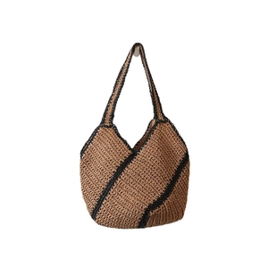 Minimalist straw tote bag with geometric black stripes for beach and holiday use