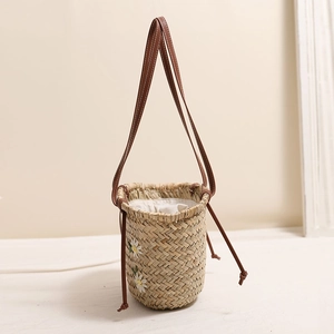 Floral embroidered straw bucket bag with leather strap for beach and vacation