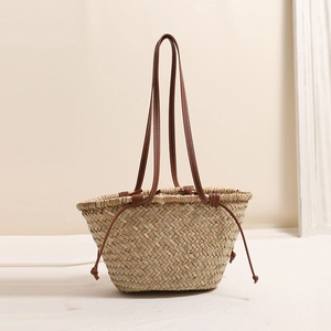 Floral embroidered straw shoulder bag with leather straps and drawstring for beach vacations