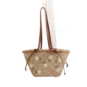 Floral embroidered straw shoulder bag with brown leather straps for summer beach vacations