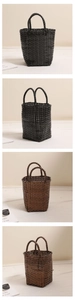 Close-up of black and brown woven basket bags with grid texture and round handles