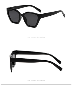 Detail view showing front and side profile of black cat eye sunglasses with glossy frames