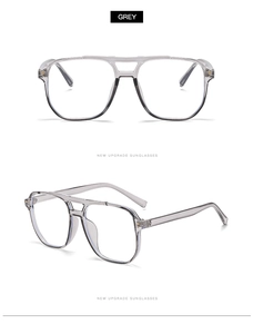 Détail de lunettes aviateur grises transparentes avec double pont et rivets métalliques