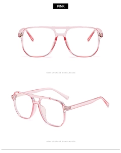 Détail de lunettes aviateur roses transparentes avec design rétro à double pont