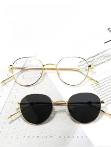 Classic small oval sunglasses with slim gold metal frames and dark grey and clear lenses