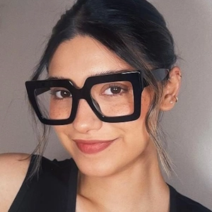 Close-up of a model wearing stylish oversized black square blue light blocking glasses