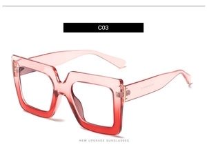 Detail view of pink and red gradient square frames with clear resin finish and specs