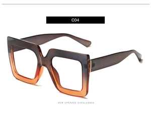 Detail of square gradient sunglasses with thick frames and golden metal accents
