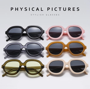 Flat lay of stylish oversized retro sunglasses in six colors including green and amber