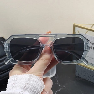 Close-up of grey translucent oversized frame sunglasses with unique double bridge structure