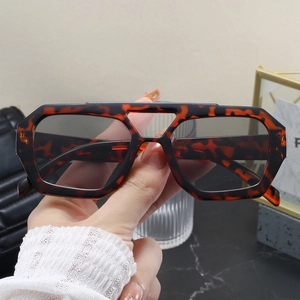 Close-up of tortoise shell sunglasses with retro double bridge and gray lenses