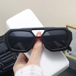 Detail of black geometric sunglasses with unique double-bridge hollow frame design