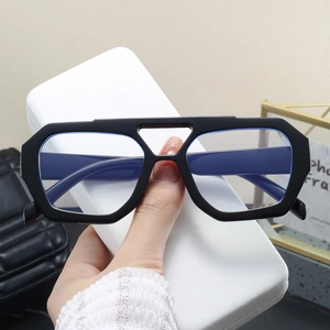 Detail of chunky black geometric glasses with blue light blocking lenses and case