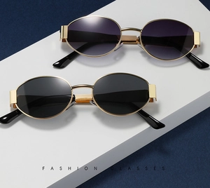 Close-up of sleek oval sunglasses in gold metal frame with black and purple gradient lenses