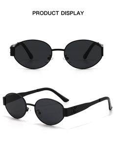 Detail view of oval sunglasses with metallic triomphe logo on the temple and black frames