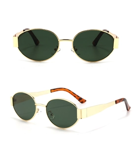 Detail showing slim gold metal frame of small oval sunglasses with tortoiseshell tips