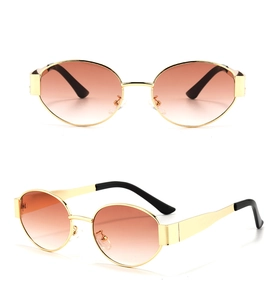 Detailed views of small oval metal sunglasses with gold frames and brown gradient lenses