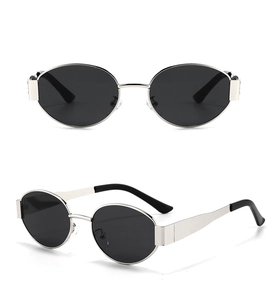 Detail view of oval metal sunglasses with black lenses and slim silver frames