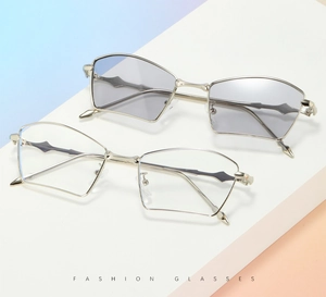 Close-up of geometric metal frame glasses with transparent and light gray lenses