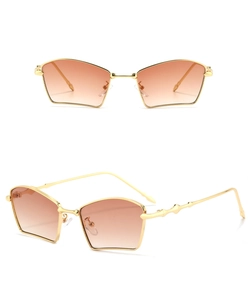 Detail view of gold geometric metal sunglasses with brown gradient lenses and wavy temples