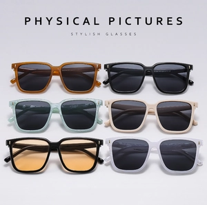 Flat lay of square sunglasses in multiple colors including amber and marble frames