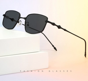 Detail of square sunglasses featuring slim metal frames and textured skeleton temples